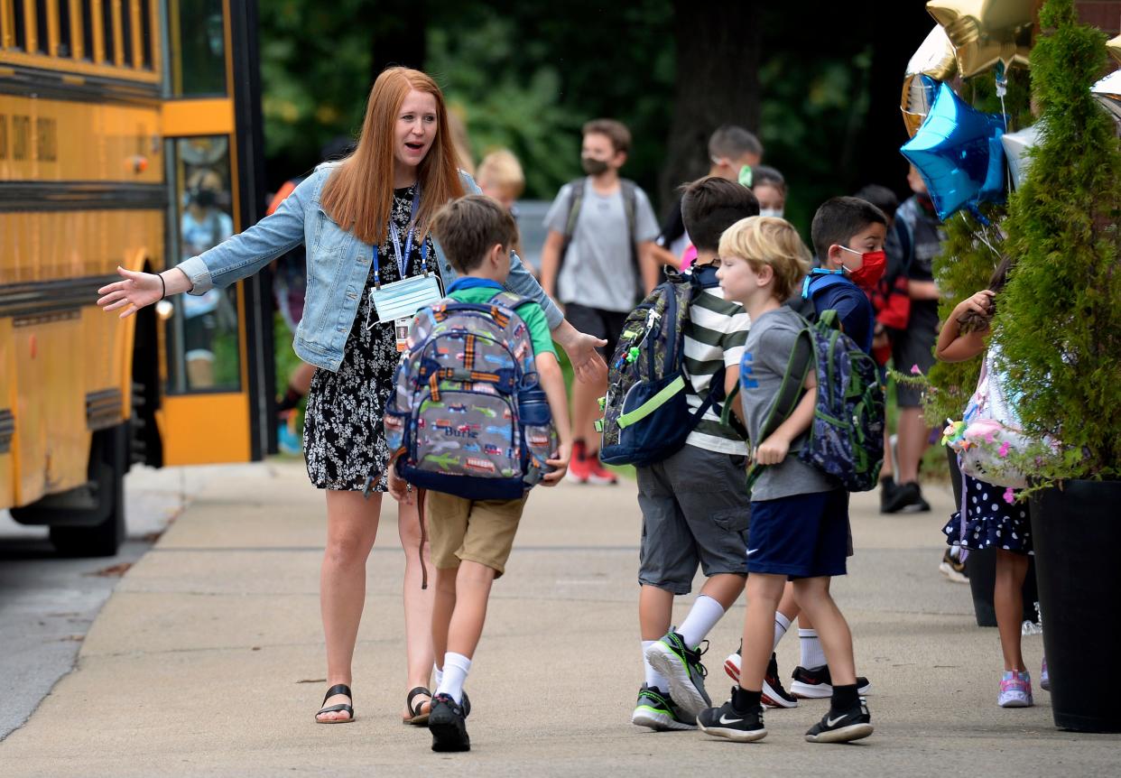 School psycologist, Dana Hood greets students as they arrive for the first day of school at Edmondson Elementary School on Friday, August 6, 2021 in Brentwood, Tenn. 