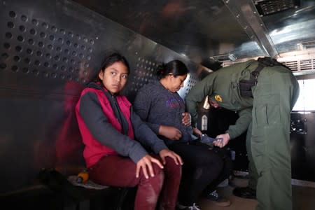 FILE PHOTO: Guatemalan migrants Ismelda Cipriano, 31, and her daughter Petronila Cipriano, 12, sit in a truck after surrendering to U.S. Border Patrol Agents in El Paso