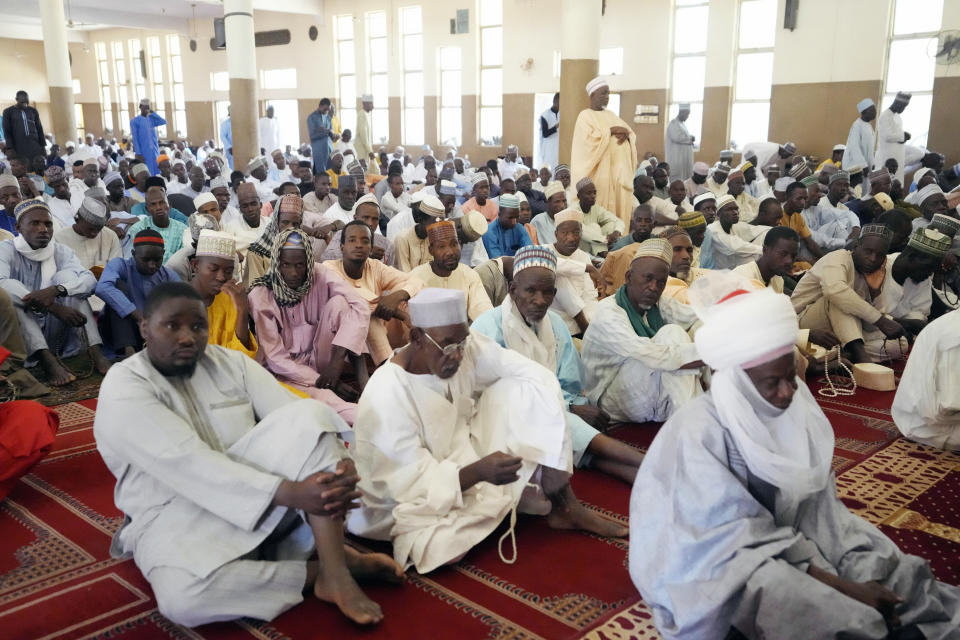 Muslim faithful listen to a sermons by an Imam, before a traditional Friday prayers at the Moddibo Adama Mosque in Yola Nigeria, Friday, Feb. 24, 2023. On Feb. 25, voters will choose among 18 candidates in a first-round vote to succeed incumbent President Muhammadu Buhari, but despite being Africa's largest economy and and one of its top oil producers, Nigeria is in economic crisis. (AP Photo/Sunday Alamba)