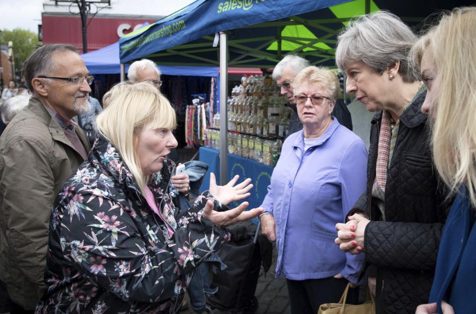 Theresa May is confronted by an angry voter (Reuters)