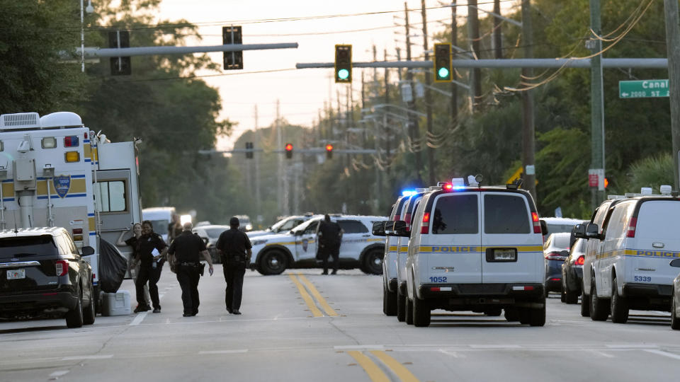 Law enforcement officers investigate the scene of a mass shooting at a Dollar General store Saturday, Aug. 26, 2023, in Jacksonville, Fla. (AP Photo/John Raoux)