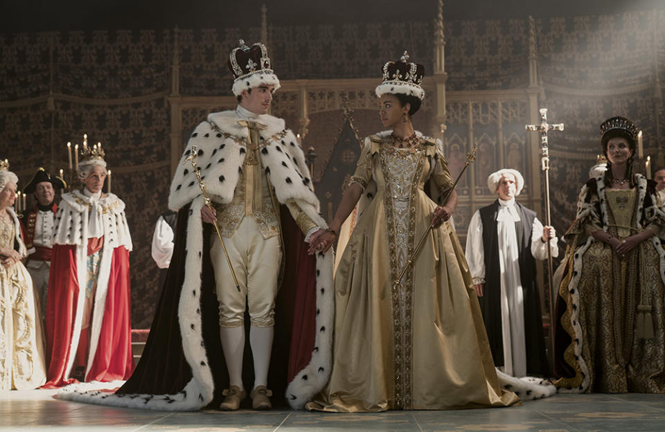 (L to R) Corey Mylchreest as Young King George, India Amarteifio as Young Queen Charlotte, Michelle Fairley as Princess Augusta in Queen Charlotte: A Bridgerton Story.