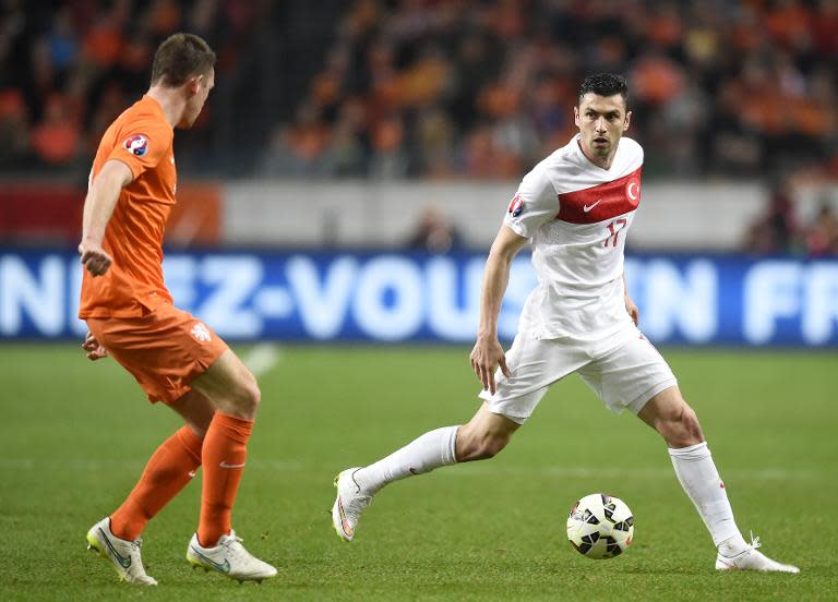 Dutch's defender Stefan de Vrij (L) vies with Turkey's Forward Burak Yilmaz (R) during the Euro 2016 qualifying round football match between Netherlands and Turkey at the Arena Stadium, on March 28, 2015 in Amsterdam