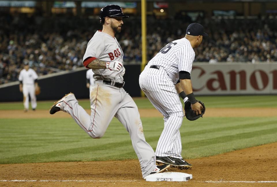 Boston Red Sox Ryan Roberts is out at first on a sixth-inning groundout as New York Yankees first baseman Carlos Beltran (36) takes the throw in the MLB American League baseball game at Yankee Stadium in New York, Sunday, April 13, 2014. Beltran, who usually plays in the outfield, was filling in for the injured Francisco Cervelli, who was filling in for the injured Mark Teixeira. (AP Photo/Kathy Willens)