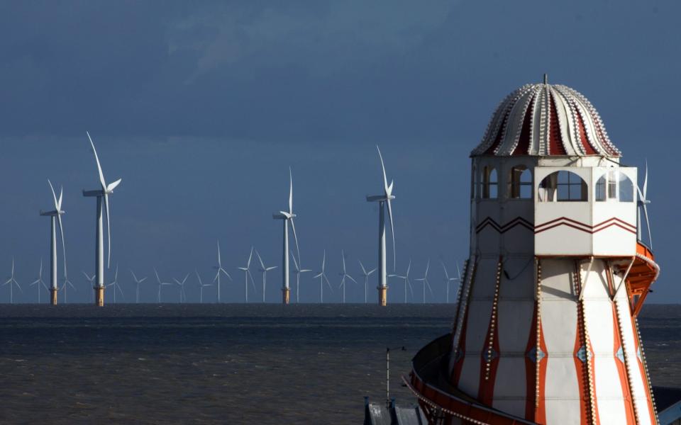 Offshore wind turbines off the coast past the Clacton Pier in Clacton On Sea - Chris Ratcliffe/Bloomberg