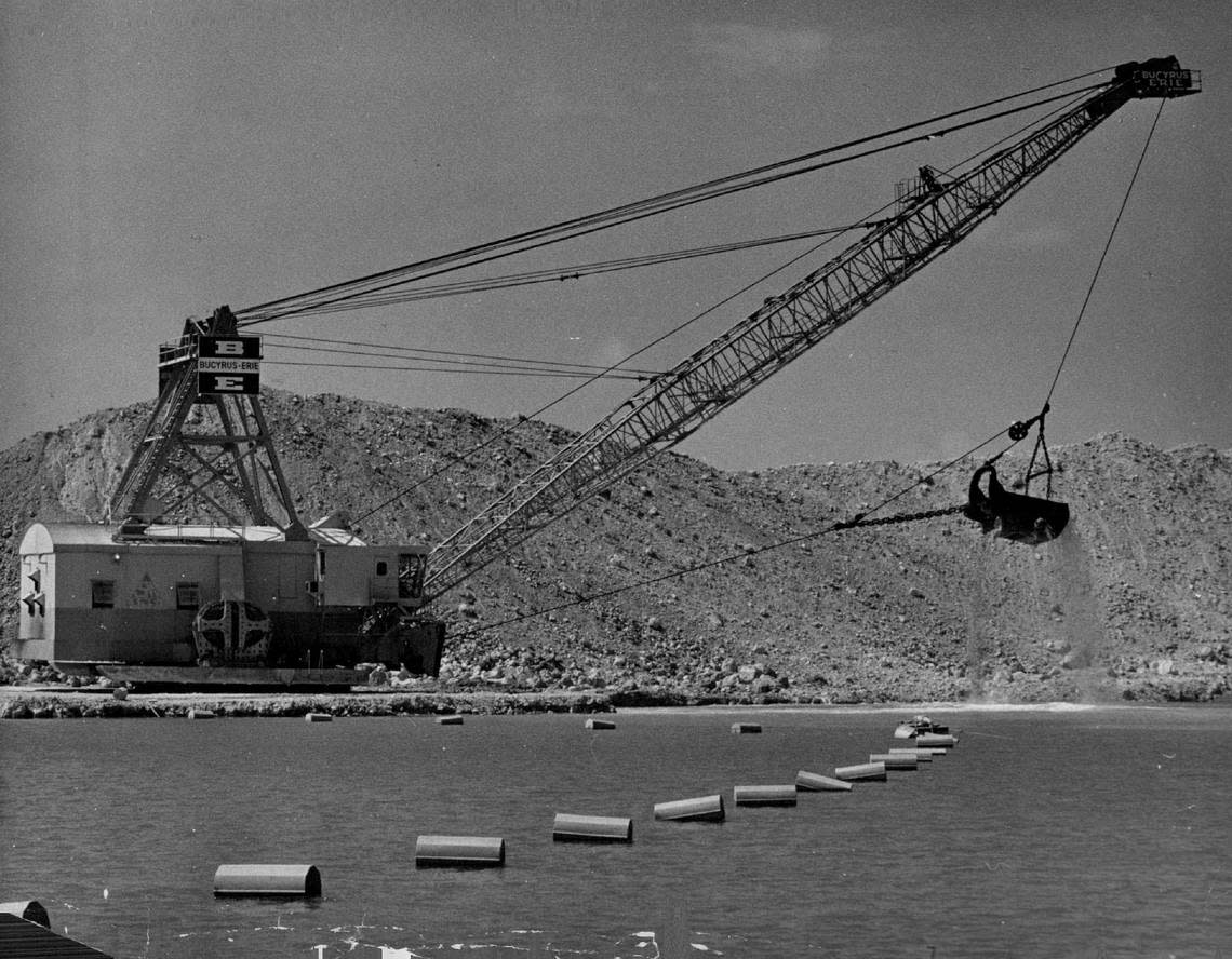 A gigantic bucketed drag line picks up about 20 yards of native oolite at a time in rock pit near the Hialeah Gardens exit of new turnpike extension in 1974.