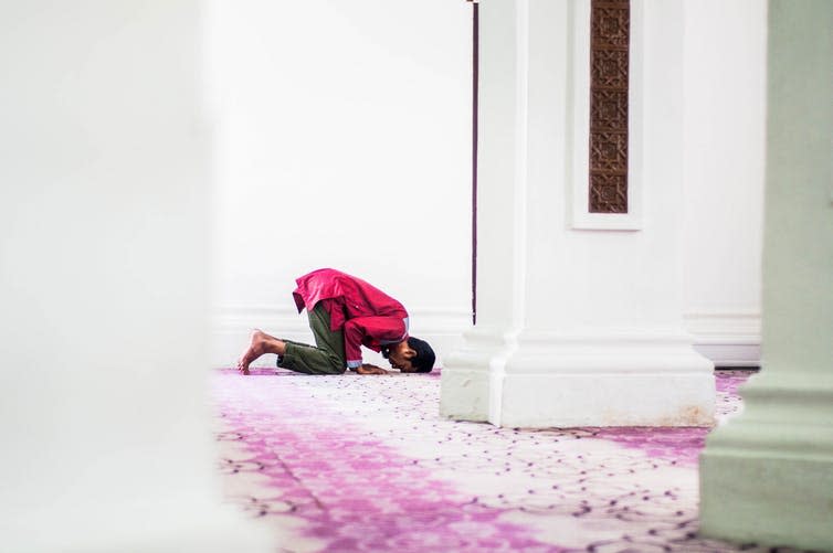 Man praying in a mosque