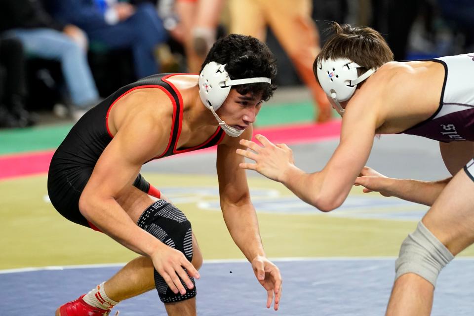 Riley Halal of Bergen Catholic, left, wrestles Jack Myers of Morristown in a 132-pound bout on day one of the NJSIAA state wrestling tournament in Atlantic City on Thursday, March 2, 2023.