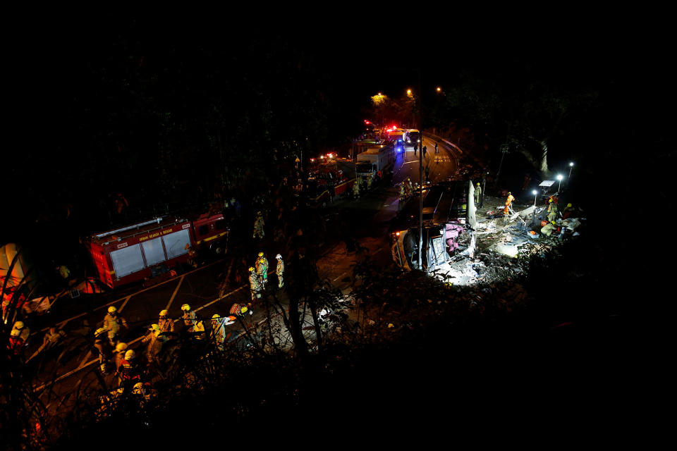 <p>Rescuers work near a crashed bus in Hong Kong, China, Feb. 10, 2018. (Photo: Bobby Yip/Reuters) </p>