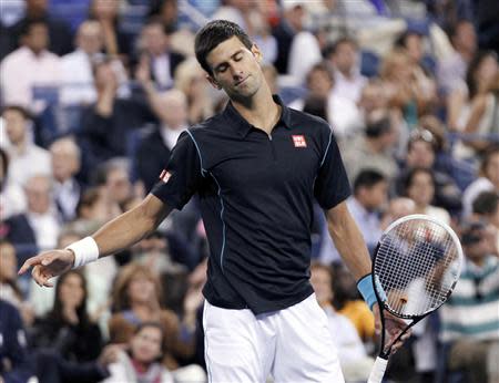 Novak Djokovic of Serbia reacts in the third set of his quarter-final match against Mikhail Youzhny of Russia at the U.S. Open tennis championships in New York September 5, 2013. REUTERS/Shannon Stapleton