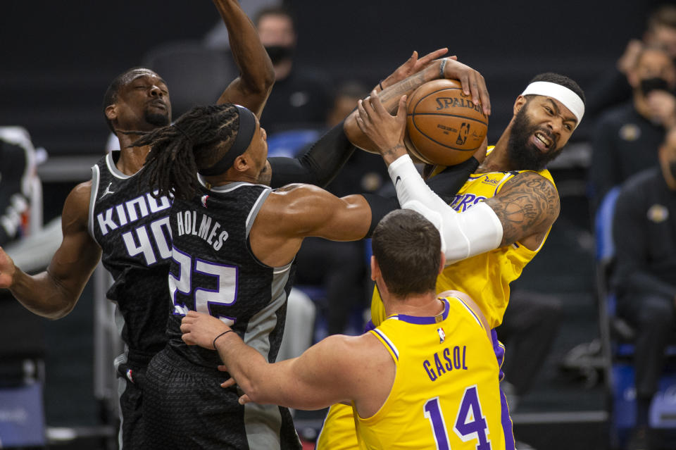 Los Angeles Lakers forward Markieff Morris, right, picks up a rebound as he is defended by Sacramento Kings center Richaun Holmes (22) during the first quarter of an NBA basketball game in Sacramento, Calif., Friday, April 2, 2021. (AP Photo/Hector Amezcua)