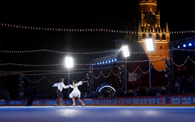 Figure skaters perform during the opening of an outdoor skating rink in the Red Square in Moscow