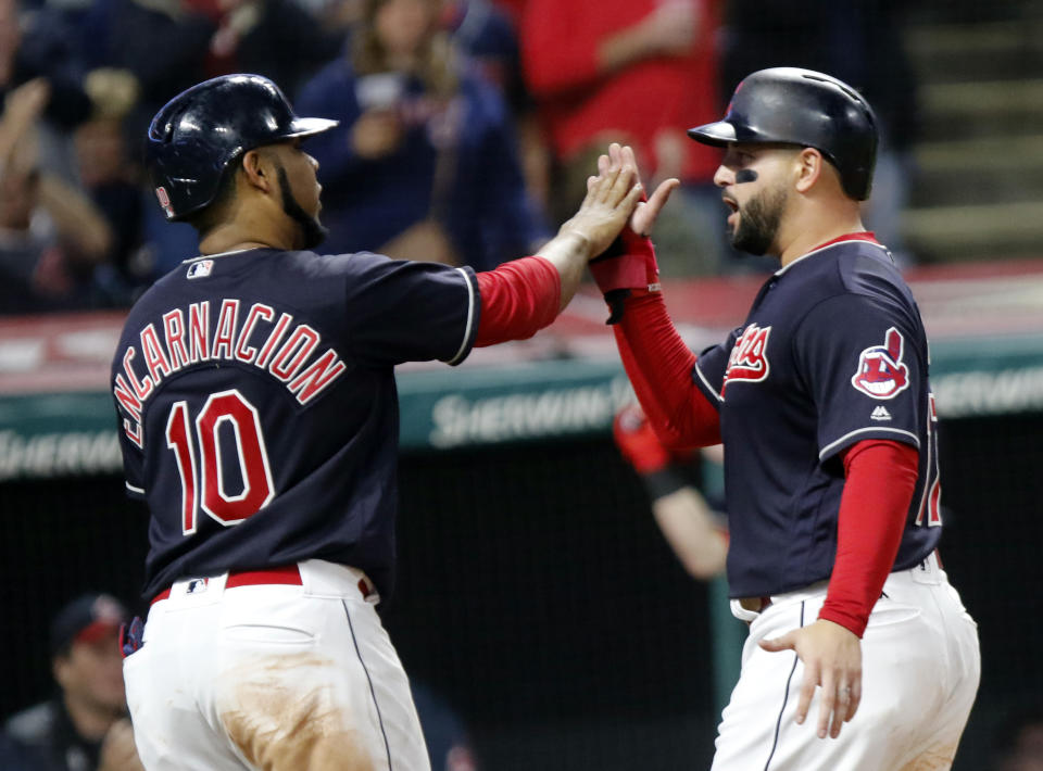 Cleveland Indians' Edwin Encarnacion (10) and Yonder Alonso celebrate scoring on a hit by Melky Cabrera in the fourth inning of a baseball game against the Boston Red Sox, Sunday, Sept. 23, 2018, in Cleveland. (AP Photo/Tom E. Puskar)