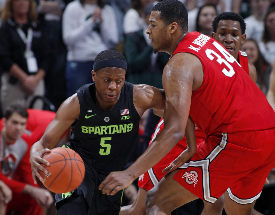 Michigan State's Cassius Winston, left, drives against Ohio State's Kaleb Wesson during the first half of an NCAA college basketball game, Sunday, Feb. 17, 2019, in East Lansing, Mich. (AP Photo/Al Goldis)