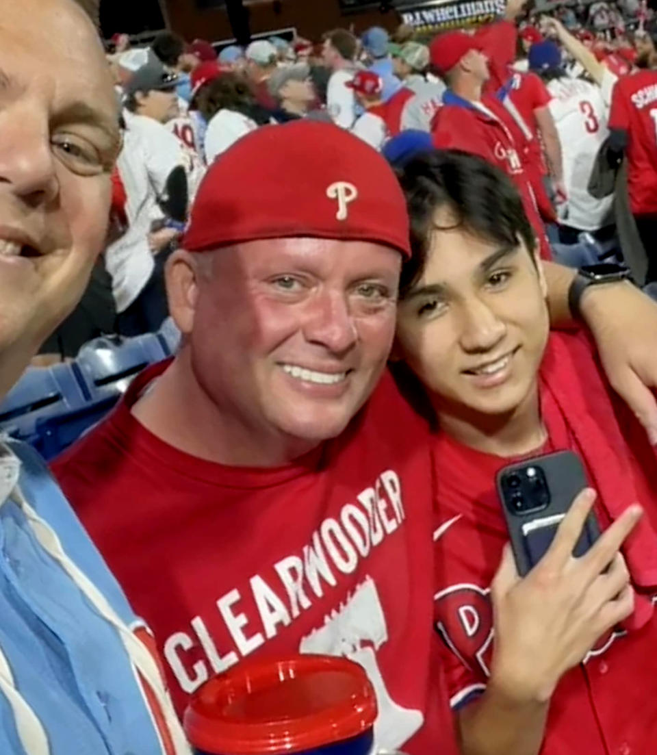 When Chris Greenwell realized that Cody Newton, 16, was at the game alone, he struck up a conversation. After chatting, Greenwell shared Newton's story on social media and people across the country and the Phillies wanted to help Newton enjoy the team's first playoff season since Newton's dad died. (Courtesy Chris Greenwell)