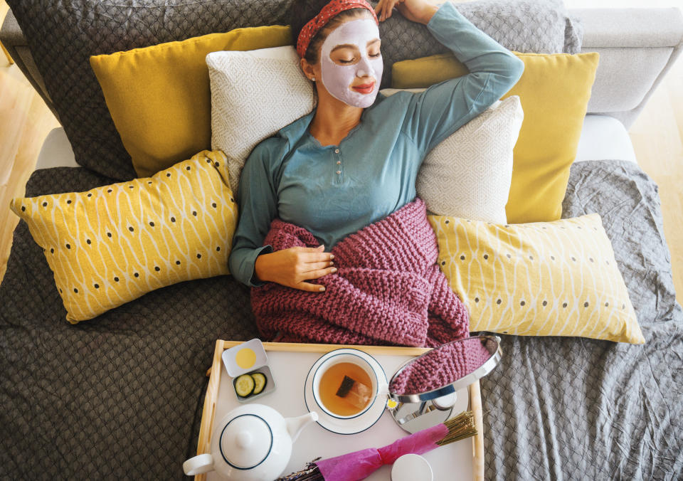 Young woman with a mask on her face is enjoying a morning weekend. (Photo: Aja Koska via Getty Images)