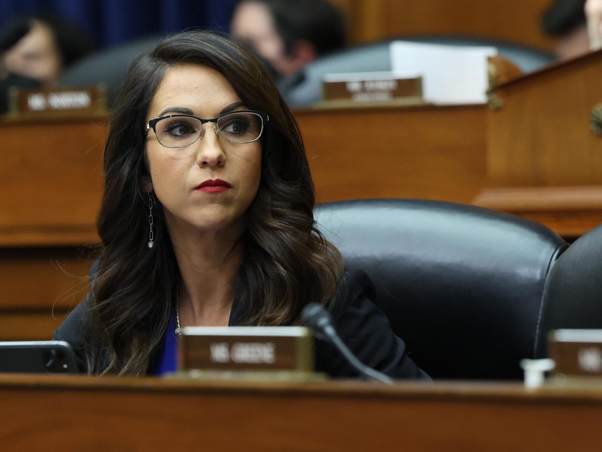 Lauren Boebert sitting in a chair during a meeting with other US House Representatives/