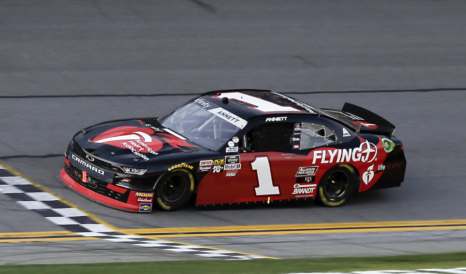 Michael Annett (1) crosses the finish line to win the NASCAR Xfinity series auto race at Daytona International Speedway, Saturday, Feb. 16, 2019, in Daytona Beach, Fla. (AP Photo/Terry Renna)