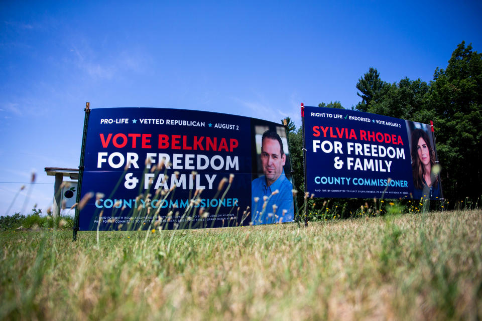 Campaign signage for Republican candidates for County Commissioner Roger Belknap and Sylvia Rhodea sit Thursday, July 21, 2022, near Jenison.