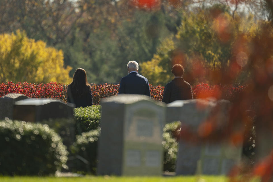 President-elect Joe Biden, center, visits the cemetery where his son Beau, his wife Neilia, and daughter Naomi are buried at St. Joseph on the Brandywine Catholic Church, Sunday, Nov. 8, 2020, in Wilmington, Del. (AP Photo/Carolyn Kaster)