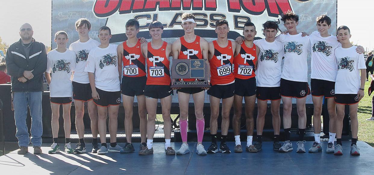 Coach Ralph Kroetch (left) is pictured with the Philip High School boys team that won the State B title recently in the 2023 State High School Cross Country Championships at Yankton Trail Park in Sioux Falls.