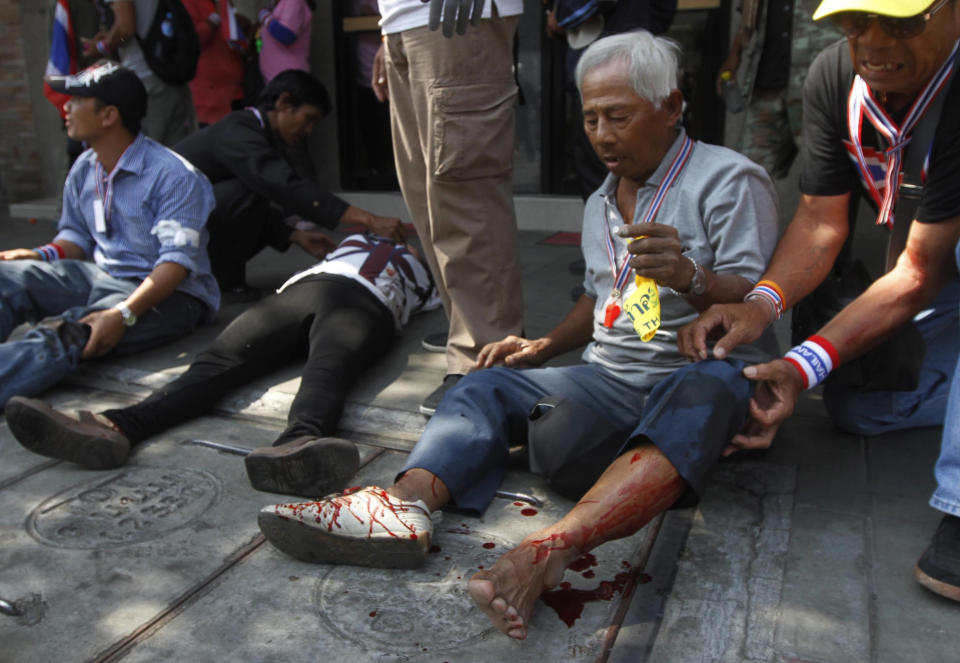 Anti-government protesters injured in an explosion during a demonstration wait for doctors in Bangkok, Thailand, Friday, Jan. 17, 2014. Dozens of people were wounded when an explosion hit anti-government demonstrators marching through Bangkok in some of the bloodiest violence reported this year. Protest spokesman Akanat Promphan said an explosive device was thrown into a truck driven by demonstrators that was several dozen meters (yards) ahead of the movement leader Suthep Thaugsuban, who was not wounded in the blast. (AP Photo/Astv Manager Newspaper) THAILAND OUT