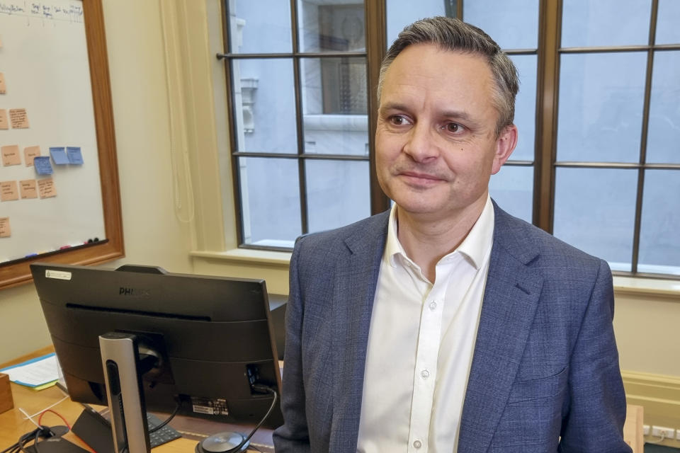 New Zealand's Climate Change Minister James Shaw speaks during an interview with The Associated Press in his office in Wellington, New Zealand, Wednesday, Oct. 13, 2021. The coronavirus pandemic has shown that humans are very good at responding to an immediate crisis, says Shaw. But when it comes to dealing with a slower-moving threat like climate change, he says, we're "terribly bad." (AP Photo/Sam James)