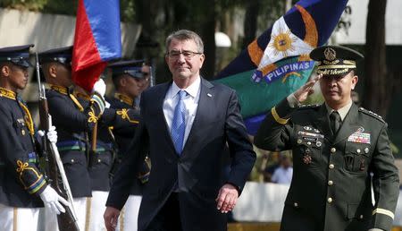 U.S. Defence Secretary Ash Carter walks past honour guards at Camp Aguinaldo to attend the closing ceremony of a U.S.-Philippine military exercise dubbed "Balikatan" (shoulder to shoulder) in Quezon City, Metro Manila, April 15, 2016. At right escorting him is Lieutenant General Glorioso Miranda. REUTERS/Erik De Castro