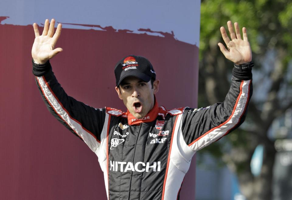 Helio Castroneves, of Brazil, waves to the fans after finishing third in the IndyCar Grand Prix of St. Petersburg auto race, Sunday, March 30, 2014, in St. Petersburg, Fla. (AP Photo/Chris O'Meara)