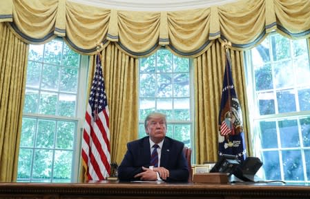 U.S. President Trump sits behind the Resolute Desk in the Oval Office at the White House in Washington