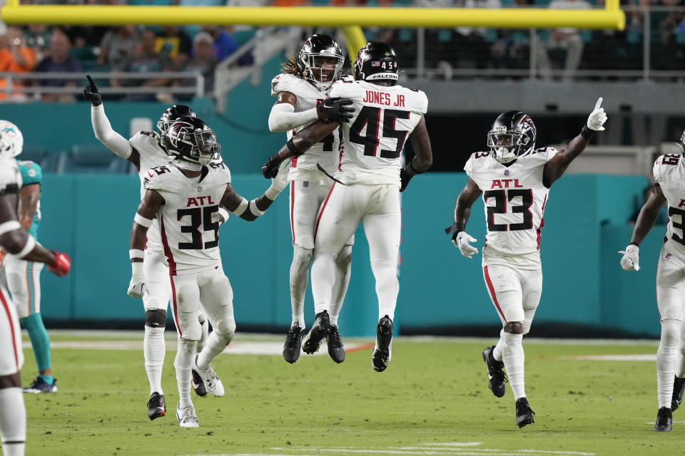 Atlanta Falcons safety Lukas Denis, center, celebrates with Mike Jones Jr. (45) after intercepting a pass in the second half of a preseason NFL football game against the Miami Dolphins, Friday, Aug. 11, 2023, in Miami Gardens, Fla. (AP Photo/Marta Lavandier)
