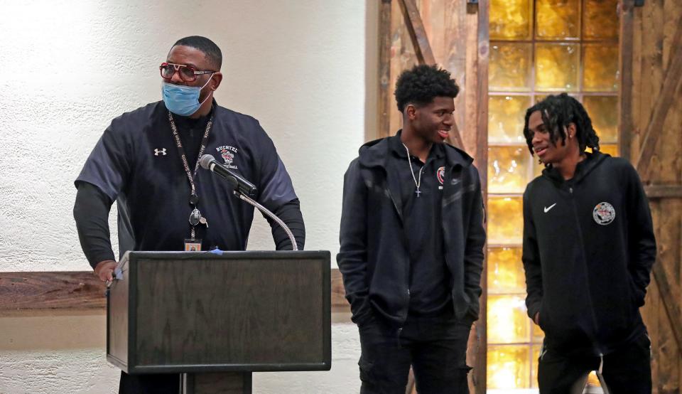 Buchtel boys basketball coach Rayshon Dent, left, introduces Qi’Marreon Marks and Diaire Pride during the Akron City Series high school basketball media day Nov. 14 at Guy’s Party Center in Akron.