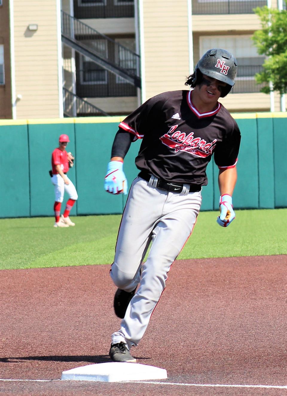 New Home's Ashton Lucio rounds third after clobbering a two-run home to run left field over Anderson left-fielder Trevor Miller, background. That gave the Leopards a 10-6 lead, runs needed in a 13-12 Game 3 victory Saturday over the Tigers.