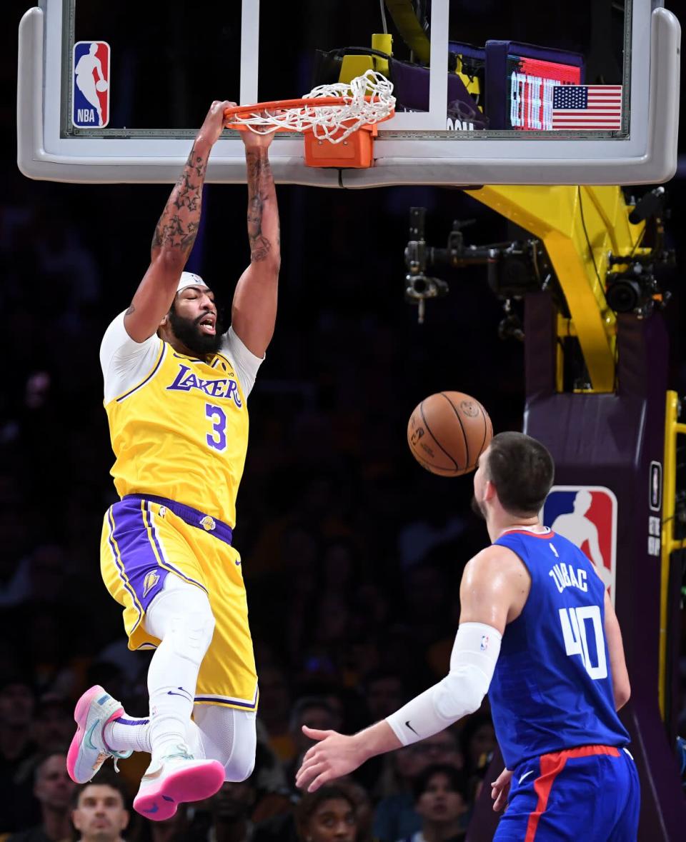 Lakers forward Anthony Davis dunks over Clippers center Ivica Zubac in the first quarter Thursday.