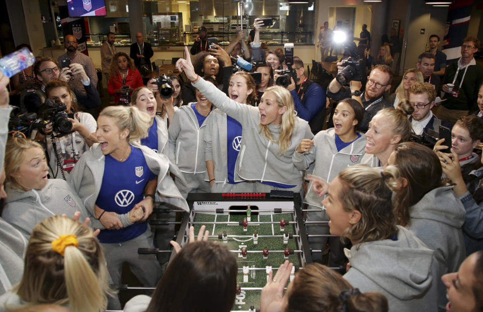 Member of the United States women's national soccer team react while while playing a foosball table featuring their likenesses during the team's Women's World Cup media day in New York, Friday, May 24, 2019. (AP Photo/Seth Wenig)