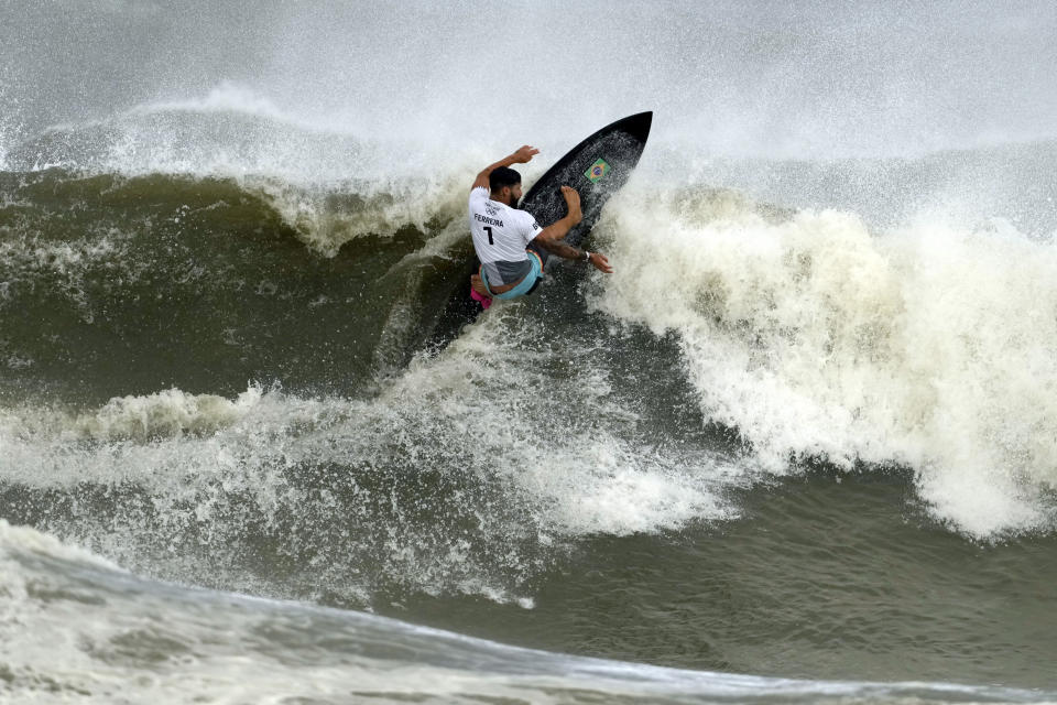 Brazil's Italo Ferreira preforms on the wave during the gold medal heat in the men's surfing competition at the 2020 Summer Olympics, Tuesday, July 27, 2021, at Tsurigasaki beach in Ichinomiya, Japan. (AP Photo/Francisco Seco)