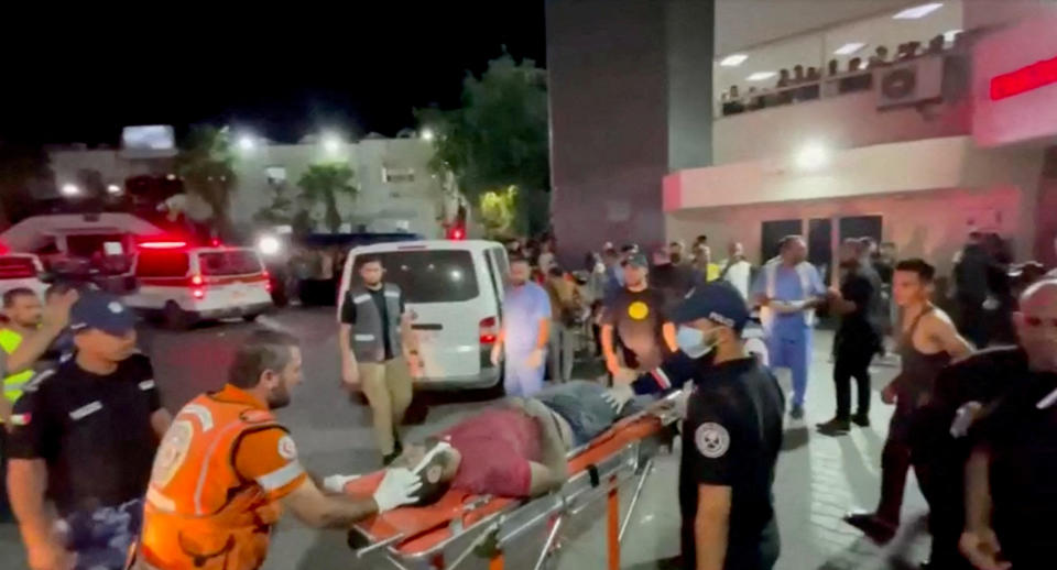 An injured person is taken into a hospital after hundreds of Palestinians were killed in a blast at Al-Ahli hospital in Gaza that Israeli and Palestinian officials blamed on each other, in Gaza City, Oct. 17, 2023. / Credit: REUTERS TV / REUTERS