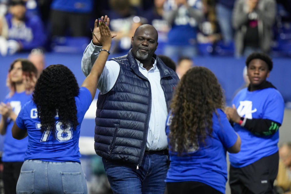 Former Indianapolis Colts offensive lineman Tarek Glenn is greeted by family members as he's inducted into the Indianapolis Colts Ring of Honor during an NFL football game between the Washington Commanders and the Indianapolis Colts in Indianapolis, Sunday, Oct. 30, 2022. (AP Photo/AJ Mast)
