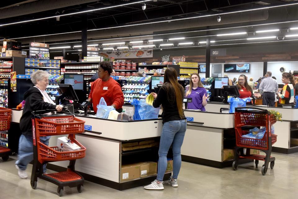 Checkout employees help shoppers May 2022 during the grand opening of Moser’s Foods at 4420 Faurot Drive. PFSbrands this week announced its acquisition of all area Moser's.