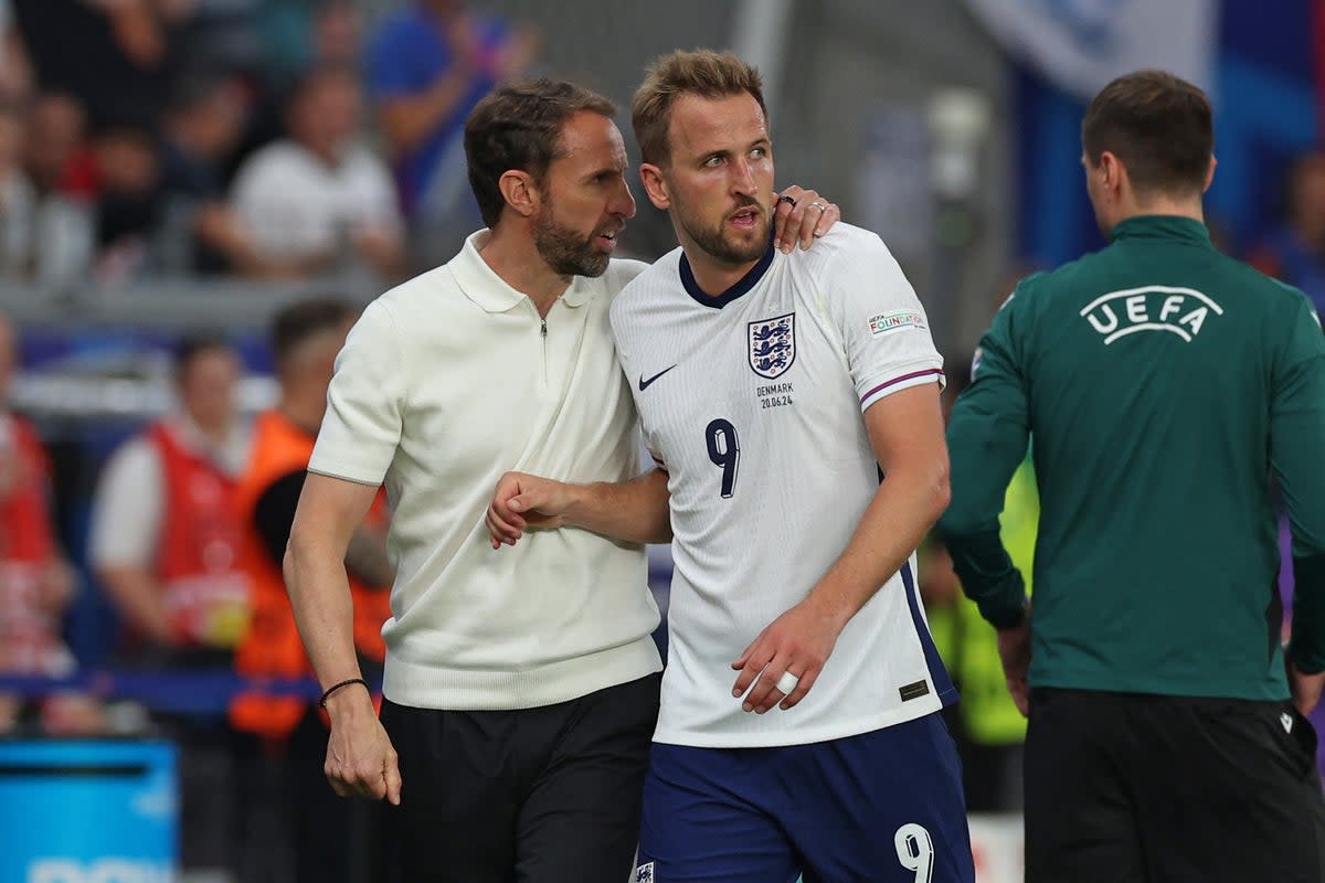 The England manager consoles captain Harry Kane (AFP via Getty Images)