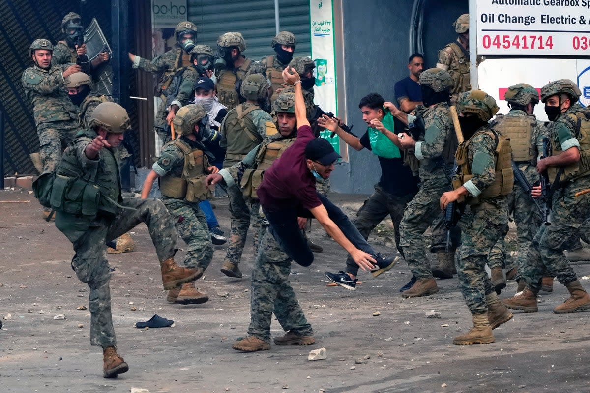 Lebanese army soldiers scuffle with protesters during a demonstration, in solidarity with the Palestinian people (Copyright 2023 The Associated Press. All rights reserved)