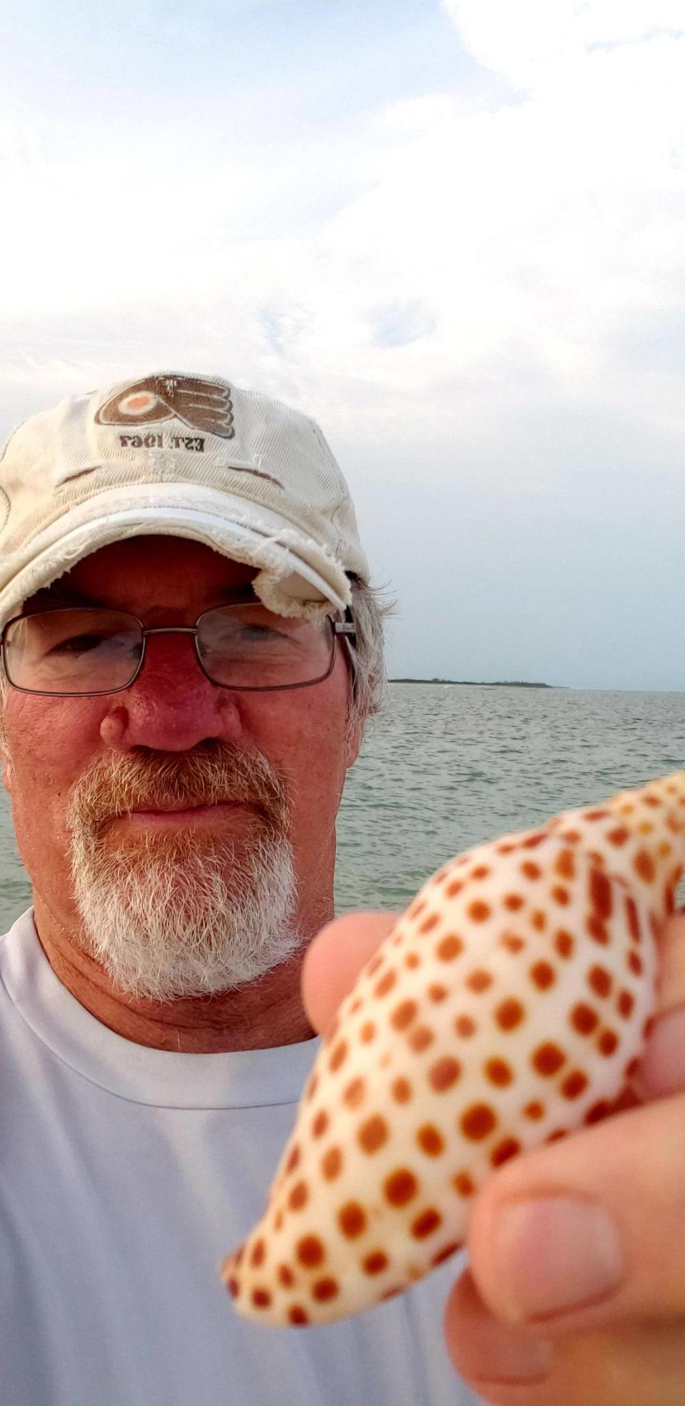 John Yates holds the junonia shell he found on Sanibel Island earlier this year.