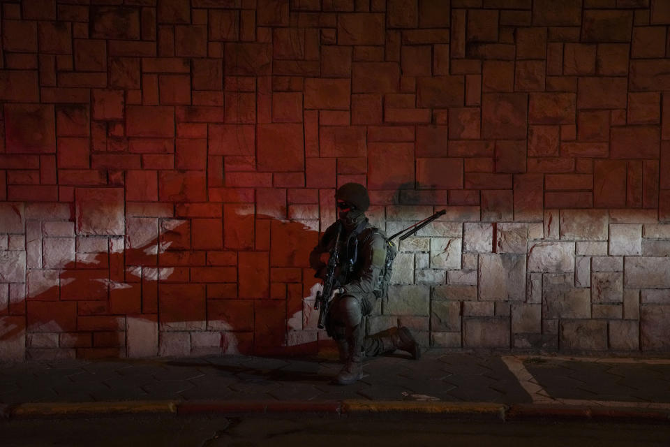 Israeli security forces search for assailants near the scene of a shooting attack in Tel Aviv, Israel, Thursday, April 7, 2022. Israeli health officials say two people were killed and at least eight others wounded in a shooting in central Tel Aviv. The shooting on Thursday evening, the fourth attack in recent weeks, occurred in a crowded area with several bars and restaurants. (AP Photo/Ariel Schalit)