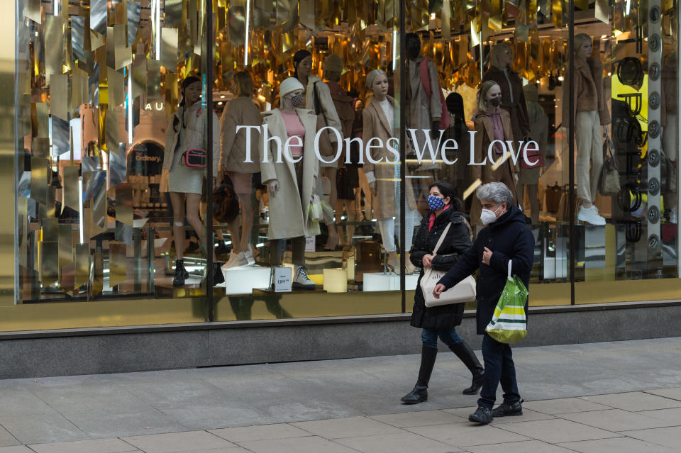 Pedestrians walk past closed shops on Oxford Street as tier 4 coronavirus restrictions are in place to limit the spread of the new strain of coronavirus as the infections continue to rise, on 22 December, 2020 in London, England. London, the south-east and the east of England entered tier 4 restrictions on Sunday, similar to the last national lockdown, with an order to stay-at-home, ban on household mixing, closing of all non-essential retail and businesses and cancellation of the planned relaxing of rules over five days around Christmas. (Photo by WIktor Szymanowicz/NurPhoto via Getty Images)