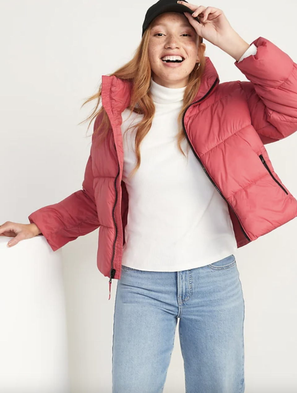 Water-Resistant Frost Free Short Puffer Jacket in pink with blue jeans (Photo via Old Navy)