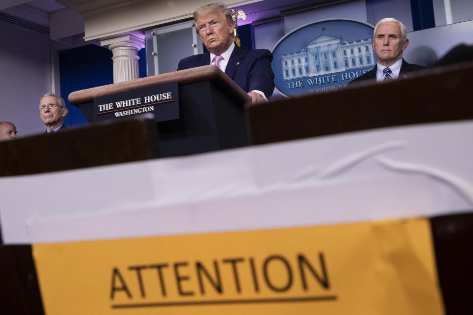 President Donald Trump speaks, accompanied by Dr. Anthony Fauci, director of the National Institute of Allergy and Infectious Diseases, left, and Vice President Mike Pence about the coronavirus in the James Brady Press Briefing Room of the White House, Wednesday, April 1, 2020, in Washington. (AP Photo/Alex Brandon)