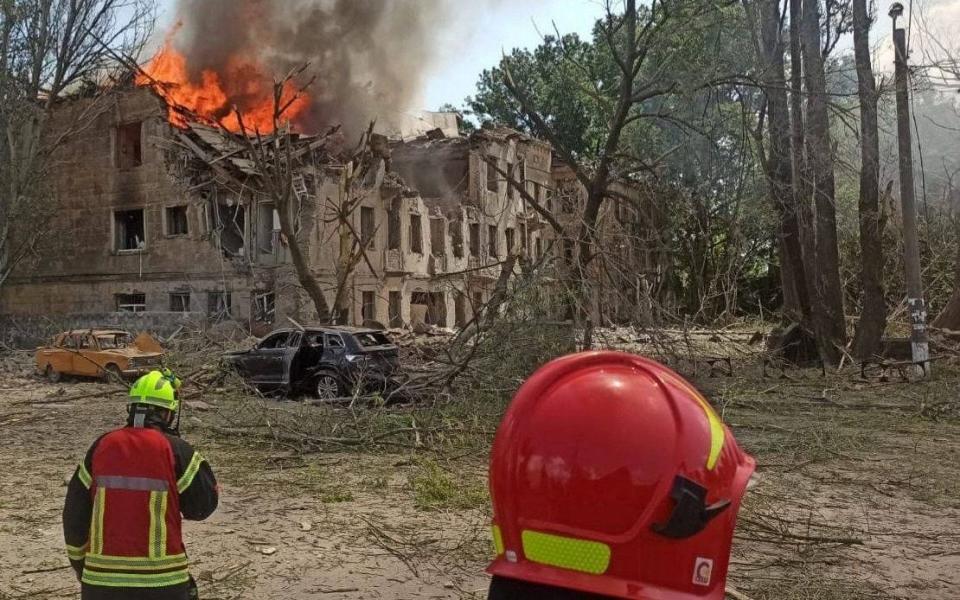 Emergency services at the scene of medical clinic destroyed by Russian missile strike in Dnipro - DNIPROPETROVSK REGIONAL MILITARY/via REUTERS