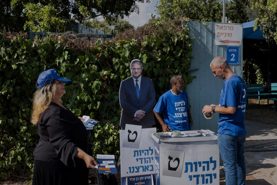 Volunteers from the Jewish Power party hand out fliers at a polling station in Nof Hagalil, Israel, on Nov. 1.<span class="copyright">Amit Elkayam—The New York Times/Redux</span>