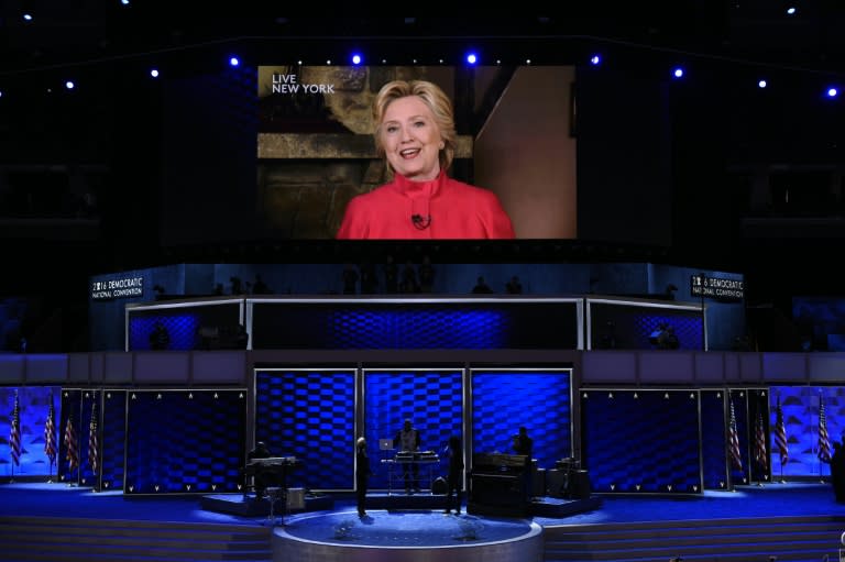 Democratic presidential nominee Hillary Clinton addresses the second evening session of the Democratic National Convention from a screen, on July 26, 2016 in Philadelphia