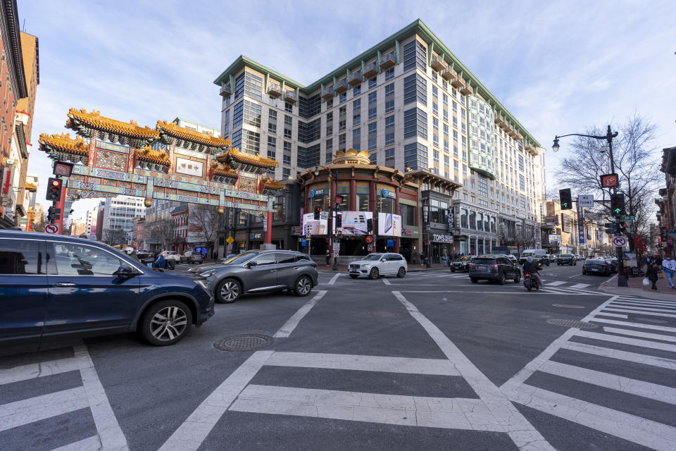 The Friendship Archway is seen to the left of the Capitol One Arena before an NHL hockey game between the Washington Capitals and the New Jersey Devils, Tuesday, Feb. 20, 2024, in Washington. The proposed move of the Capitals and Wizards sports teams to nearby Virginia has stoked concern in a pair of fragile Washington neighborhoods. Residents and business owners in Chinatown fear that the departure of the teams would devastate the neighborhood around the Capital One Arena. (AP Photo/Alex Brandon)